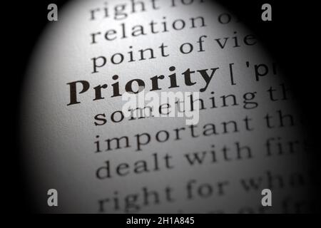 Fake Dictionary word, Dictionary definition of priority, first priority, Stock Photo