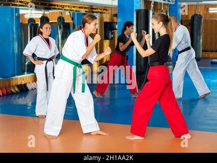 Two young female fighters sparring during mugendo training Stock Photo