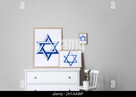 Paintings of David Stars on chest of drawers in interior of room Stock Photo