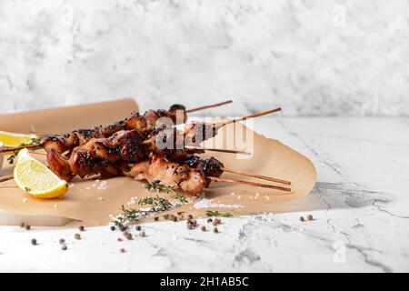 Grilled chicken skewers on table