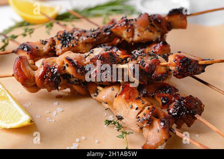 Grilled chicken skewers on parchment