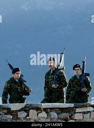 Greek solders saluting the Greek flag during the early morning flag ceremony on top of the Acropolis in  Athens, Greece. Stock Photo