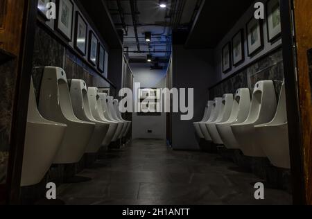 Bangkok, Thailand - Feb 14, 2020 : Public gentlemen toilet restroom. Contemporary interior of public toilet with men urinals. Interior and healthcare Stock Photo