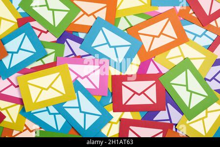Email marketing customer newsletter and online business mailing list web and Internet concept with white e-mail icon and symbol on many paper notes. Stock Photo