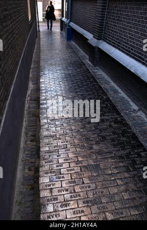Personalized cobblestones with ceramic gold layer in the Delft with names or abbreviations on them. They symbolize a story that connects peopl Stock Photo