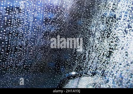 Raindrops on glass in the light of the sun Stock Photo