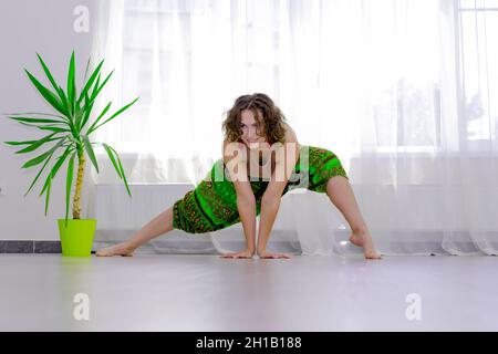 young woman practicing yoga in prayer pose Stock Photo