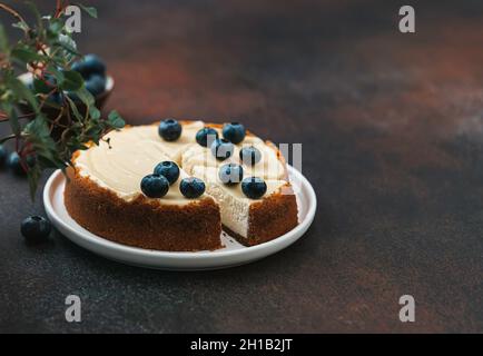 Classical New York cheesecake with blueberries. Homemade baking. Piece of cheesecake. Selective focus. Stock Photo