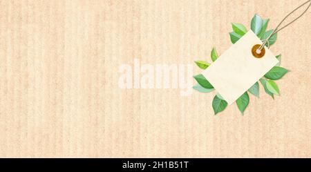 Horizontal background with paper label and green leaves on cardboard texture. Ecology, using only natural materials and zero waste concept.  Copy spac Stock Photo