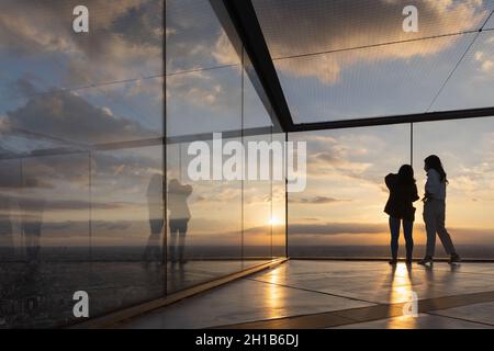 Tokyo, Japan. 15th Oct, 2021. Visitors of Shibuya Sky take photos on the upper floor of the observation deck during sunset.Shibuya Sky is a new attraction for domestic and international tourists with a great view over Tokyo. Credit: SOPA Images Limited/Alamy Live News Stock Photo