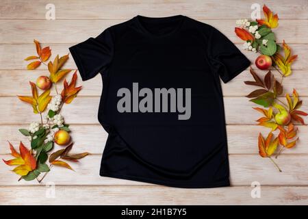 Black unisex cotton T-shirt mockup with snowberry, red and green fall leaves. Design t shirt template, tee print presentation mock up Stock Photo