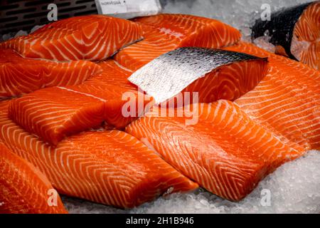 Fresh salmon steaks displayed on the ice in a fish market Stock Photo