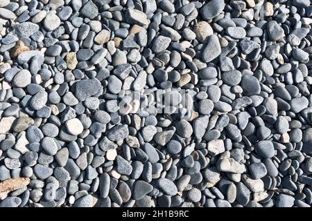 dh Grey Pebbles BEACH GUERNSEY Beaches round gray pebble stones rock rocky background texture Stock Photo
