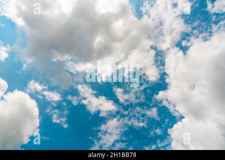 Beautiful blue sky and white cumulus clouds abstract background. Cloudscape background. Blue sky and fluffy white clouds on sunny day. Nature weather. Stock Photo