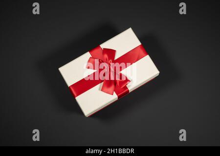Wrapped vintage gift boxes with red ribbon bow, isolated on black Stock Photo