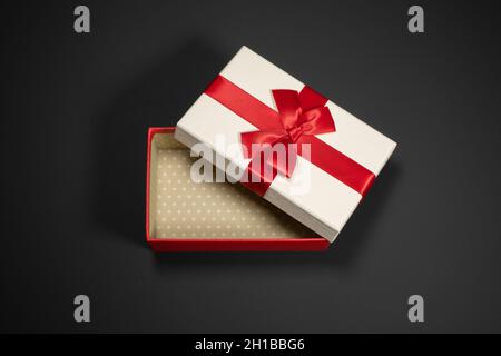 Wrapped vintage gift boxes with red ribbon bow, isolated on black Stock Photo