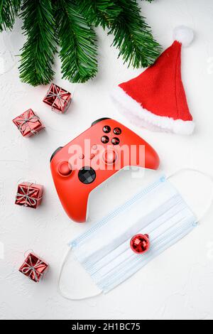 Game controller on Christmas holidays set with covid mask, on white stone table background, top view flat lay Stock Photo