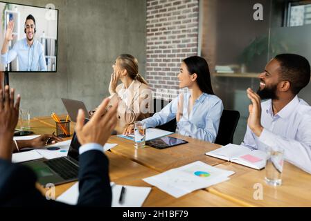 Videoconference Concept. Multiethnic business people making video call with colleague in office Stock Photo