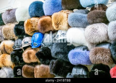 Variety of Russian fur caps souvenirs on display in a touristic  souvenir shop Onegin, Novy Arbat street, Moscow, Russia Stock Photo