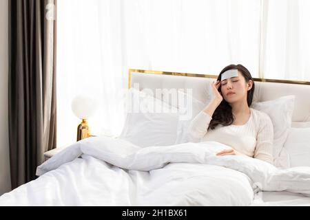 Young woman lying on bed Stock Photo
