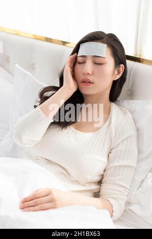 Young woman lying on bed Stock Photo
