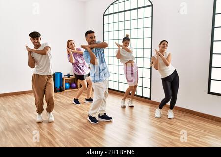 Group of young dancer smiling happy dancing choreography at dance academy. Stock Photo