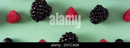 Fresh assortment berries on green background Stock Photo