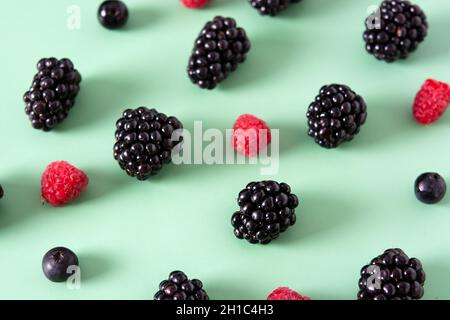 Fresh assortment berries on green background Stock Photo