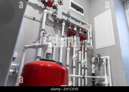 House heating system with modern plastic pipes, manometers and tubes close up in boiler room. Stock Photo