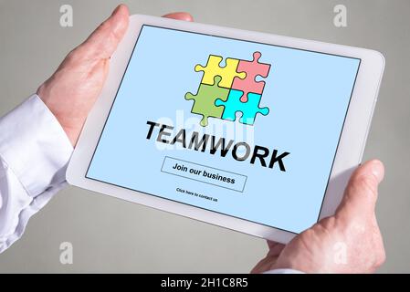 Tablet screen displaying a teamwork concept Stock Photo