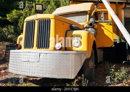 Urla, Turkey - September, 2021: Front view of a vintage yellow truck with round headlights. Stock Photo