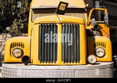 Urla, Turkey - September, 2021: Front view of a vintage yellow truck with round headlights. Stock Photo