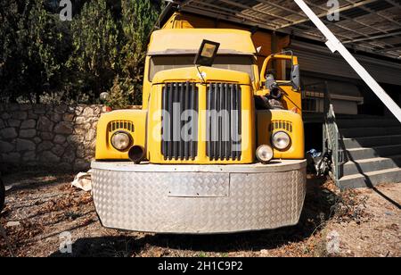 Urla, Turkey - September, 2021: Front view of a vintage yellow truck with round headlights. Stock Photo