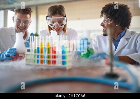 Very happy lab technicians looking biochemical reaction Stock Photo