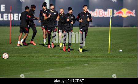 Leipzig, Germany. 18th Oct, 2021. Football: Champions League, group stage, final training before the group match Paris Saint-Germain - RB Leipzig at the Red Bull Academy. Leipzig's Andre Silva (r) runs at the head of a training group. Credit: Hendrik Schmidt/dpa-Zentralbild/dpa/Alamy Live News Stock Photo