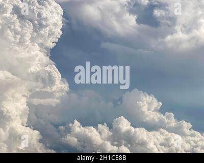 Dense white clouds contrast with grey couds Stock Photo