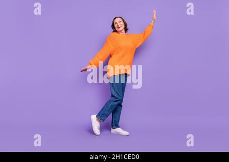 Full size profile side photo of attractive aged woman casual clothes isolated over purple color background Stock Photo