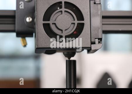 3D printer heat removing fan with a view of the printing process. A 3D printer that is printing small tubes for hobby projects Stock Photo