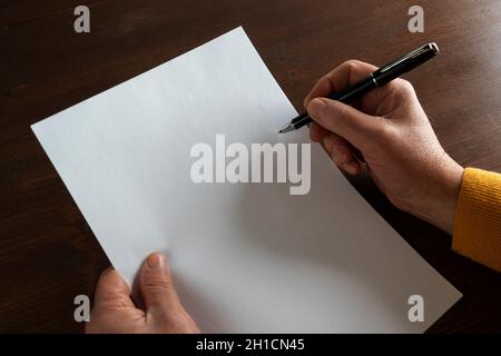 the decision to write in front of a white sheet Stock Photo