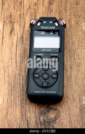 HUETTENBER, GERMANY - FEBRUARY 03, 2020: Tascam DR-05X Digital Audio recorder. Portable field recorder on wooden background. Stock Photo