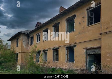 The ruins of a destroyed building in the city. Old abandoned collapsing building. Landscape with the ruins of the old buildings. Stock Photo