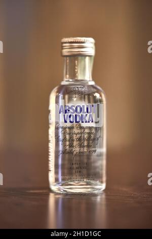 BUDAPEST, HUNGARY - CIRCA 2019: Absolut Vodka from Sweden on a table in a small bottle of 50 ml in window light Stock Photo