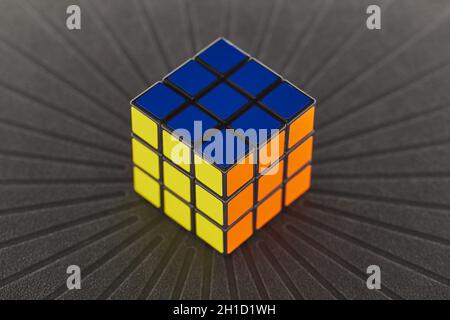 BUDAPEST, HUNGARY - CIRCA 2019: Solved Rubik's cube logic game on dark background evenly lit from all sides Stock Photo