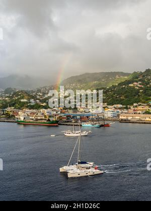 Kingstown, Saint Vincent and the Grenadines - December 19, 2018: Colorful rainbow in the sky above the Kingstown with dramatic sky, after the rain at Stock Photo