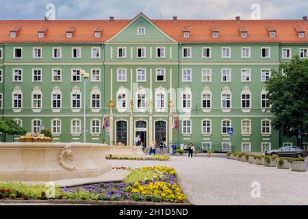 Szczecin, Poland, June 2018 Green buildings of Stettin City Council with fountains and flower decoration, petitioners going in and out Stock Photo