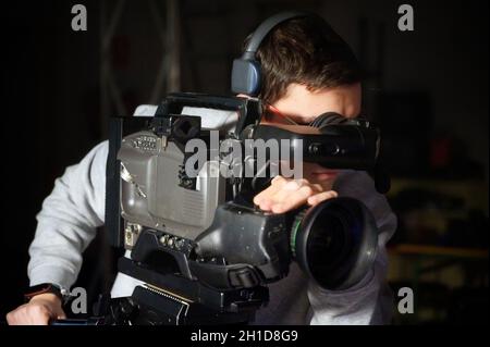 Cameraman using professional digital video camera . Stock Photo