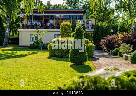 Stettin, Poland, June 2018 Headquarters of Yacht Club AZS Szczecin surrounded by green trees and decorative hedges Stock Photo