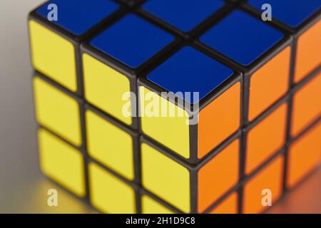 BUDAPEST, HUNGARY - CIRCA 2019: Solved Rubik's cube logic game on shiny metal surface evenly lit from all sides Stock Photo