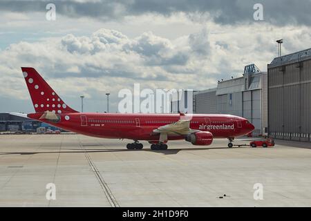 COPENHAGEN, DENMARK - CIRCA 2015: Air Greenland A330 towed into hangar at Kastrup Airport. This Airbus A330 is the largest airliner of Air Greenland. Stock Photo