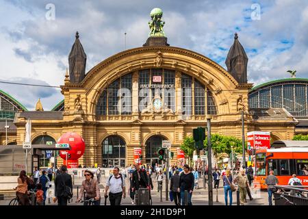 People crossing the street in front of the Frankfurt (Main) main station with the beautiful eastern façade. Above a clock, the word Hauptbahnhof can... Stock Photo